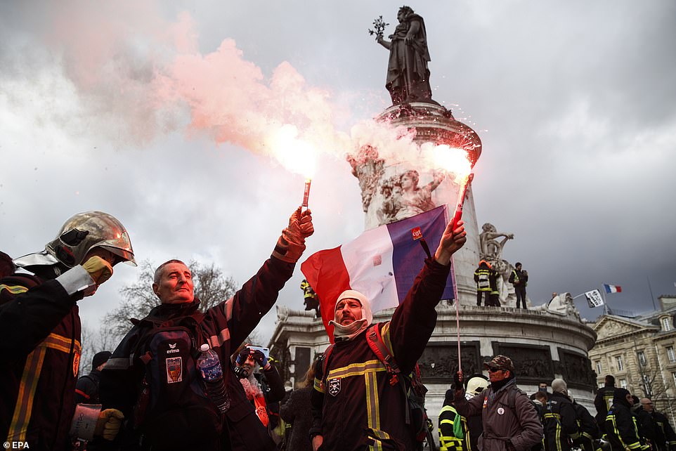 23987720 7938937 Firefighters light smoke grenades at the Republique square durin a 16 1580235649279