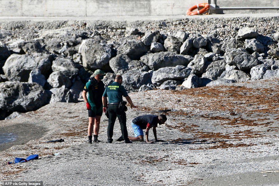 Spain Deploys Army to AID TENS OF THOUSANDS of Moroccans and Africans to Invade their Country 4 43125223 9591093 Migrants soaked with seawater kept reaching Ceuta on Tuesday alt a 454 1621343366121
