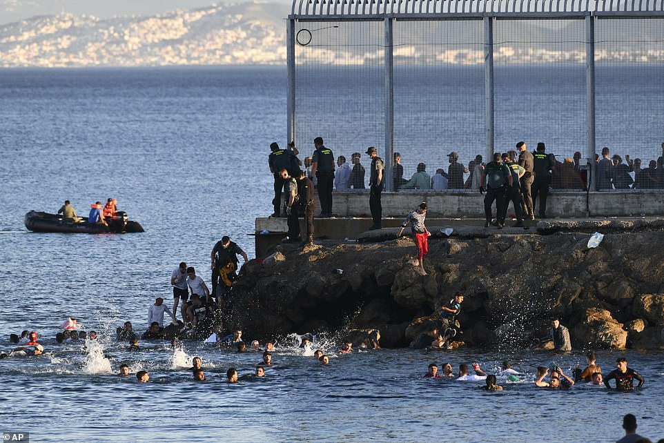 Spain Deploys Army to AID TENS OF THOUSANDS of Moroccans and Africans to Invade their Country 5 43125303 9591093 Thousands of migrants have crossed into a Spanish enclave from M a 469 1621343366130