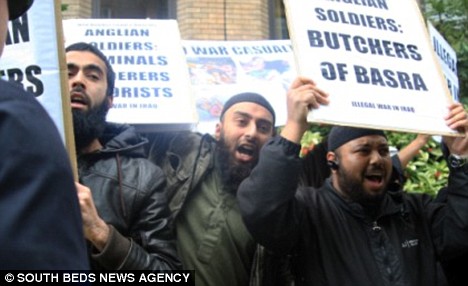 The shocking picture of a white boy aged 11 being 'converted' to Islam by radical preacher 2 Protest of hate: A crowd of fanatics shouted insults at British troops on a homecoming parade in Luton in March